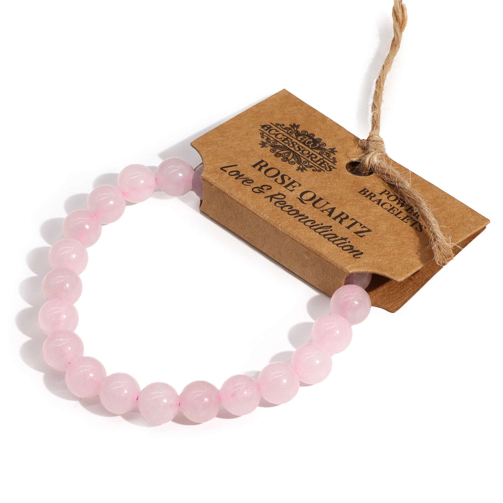 Pulsera de cuarzo rosa, elástica con cuentas redondas en tono rosado suave y acabado pulido - fomenta amor propio y armonía